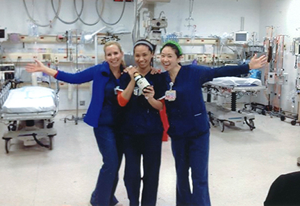 Jennifer Whalen '09 (left) and her coworkers celebrating New Years Eve with apple cider in the Elmhurst Hospital Emergency Department